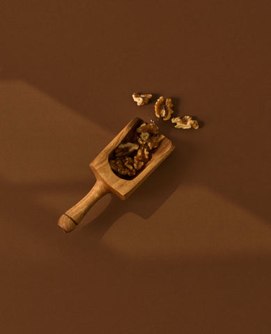 A collection of wooden scoops of various sizes, displayed against a neutral background.